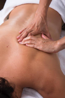 Therapist applying remedial massage techniques to a client's upper back at Foundation Health in Ballina.